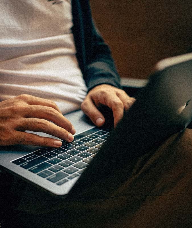 person typing on laptop